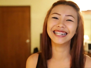 Asian smallish breasted teenager with braces